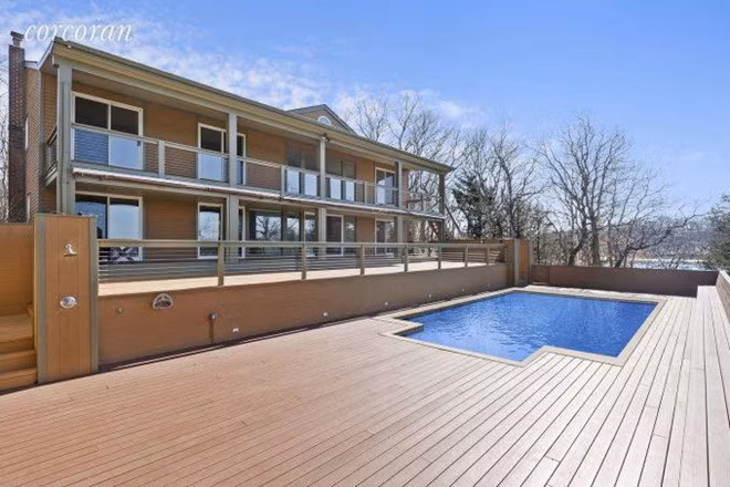 Căn biệt thự có một bể bơi ngoài trời riêng biệt, nhìn ra bờ biển dài.