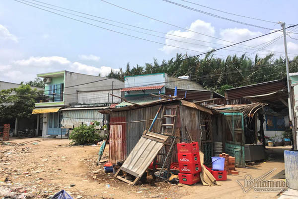 Căn phòng trọ của vợ chồng anh Dũng, 40 tuổi rộng 10 m2, giá thuê 1 triệu đồng/tháng chưa kể tiền điện nước. Anh cho biết, đã ở đây hơn 10 năm. Những ngày mưa và thủy triều dâng cao, nước đen ngòm dưới ao bên cạnh dâng lên, kèm theo rác, chất thải…tràn vào nhà, mùi hôi khó chịu. Nước rút, các chất bẩn đọng lại, ruồi muỗi bay khắp nhà. Để cải thiện, anh Dũng phải treo đồ lên cao, chắn cửa ra vào. Chỗ ngủ thì dùng gạch và thân cây kê lên.