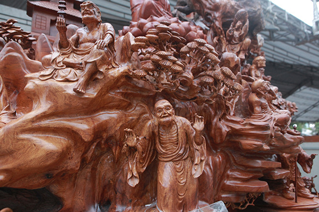 Toàn bộ gốc gỗ nu hương được đánh bóng, chạm khắc 18 vị La Hán rất tinh xảo. Mỗi vị La Hán mang một vẻ được kết hợp với phong cảnh tạo nên một bức tranh phong thủy, hữu tình.