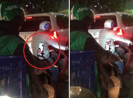 Dung cho den do, tai xe Grab tranh thu goi dien cho vo con