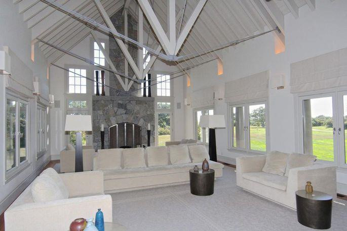 Phòng khách rộng lớn, ngập tràn ánh sáng tự nhiên từ những ô cửa bao quanh. Căn phòng được bài trí cầu kỳ, đặc biệt là các dây kim loại được treo lơ lửng trên trần nhà.