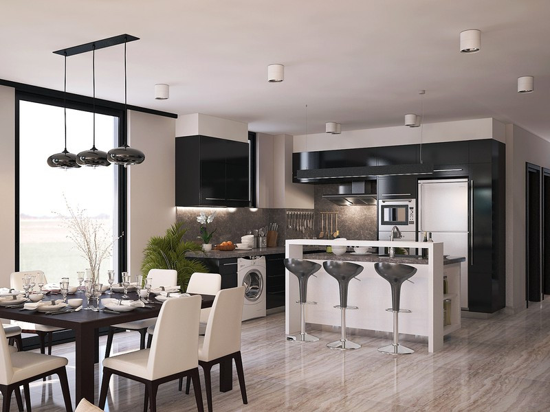 Nhà bếp bố trí nội thất hiện đại. Một bàn đảo đặt ngay giữa bàn ăn và nhà bếp để tạo khoảng hở cho cả hai.