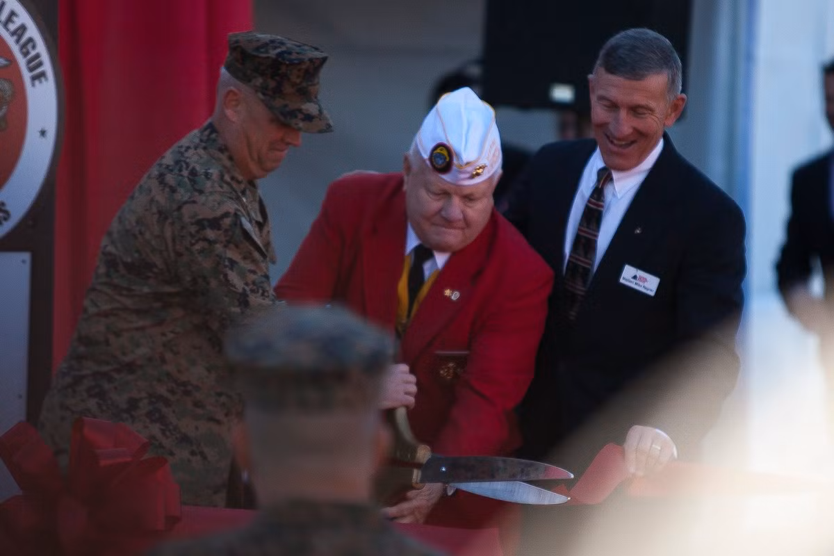 Các sĩ quan và cựu quan chức quân đội cùng khách mời dùng chiếc kéo khá lớn để cắt băng khai trương triển lãm. Cần đến 2 người để sử dụng chiếc kéo, một biểu tượng cho tinh thần đoàn kết của Thủy quân lục chiến. Ảnh: Business Insider