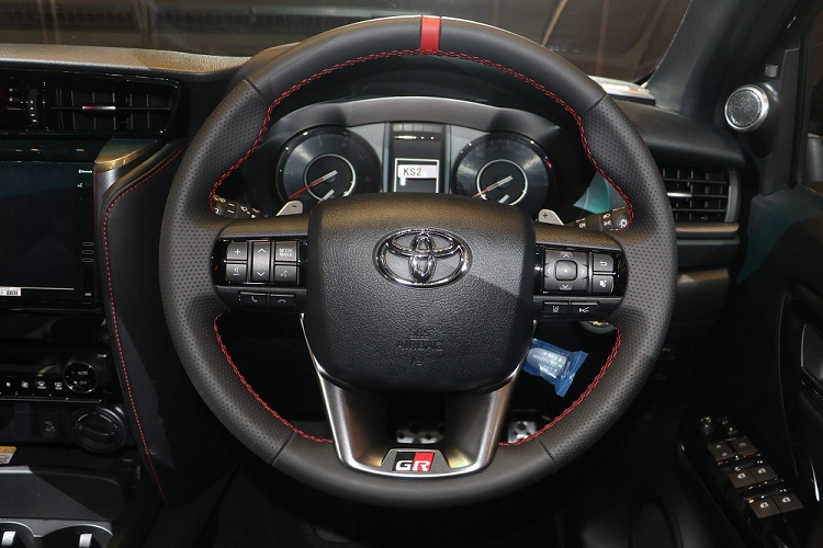 Tương tự như vậy, cần số của xe cũng được bọc bằng da nhân tạo và ốp màu bạc ám khói. Khu vực còn lại của cụm điều khiển trung tâm được ốp giả sợi carbon nhằm tăng vẻ thể thao.