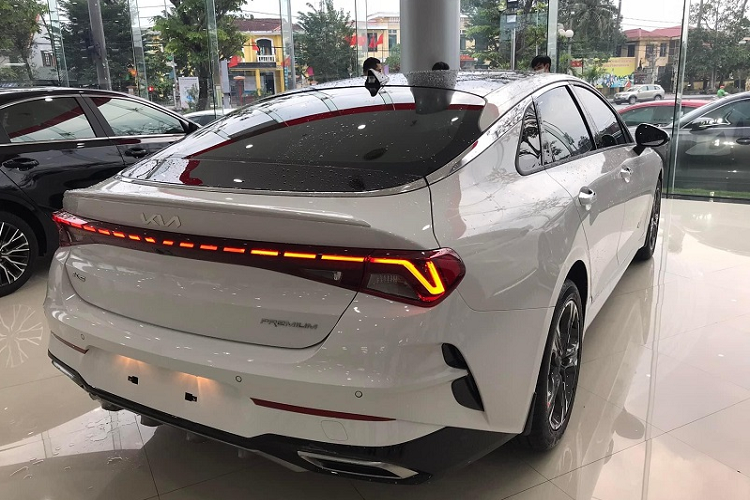 Kia K5 GT-Line 2022 mới đang có mặt tại đại lý được trang bị bộ la-zăng 5 chấu kép cỡ 18 inch thiết kế thể thao. Xe còn có gương chiếu hậu chỉnh điện, gập tự động và tích hợp đèn báo rẽ. Ở khu vực đuôi xe là cụm đèn hậu thiết kế mới với cấu trúc LED đứt đoạn trải dài hết chiều rộng. Ngoài ra phiên bản thể thao này còn có hốc gió dạng vây cá nằm đối xứng hai bên, nắp cốp dập nổi mạnh mẽ, cản va sau tích hợp bộ khuếch tán cơ bắp và ống xả hình thang mạ chrome.