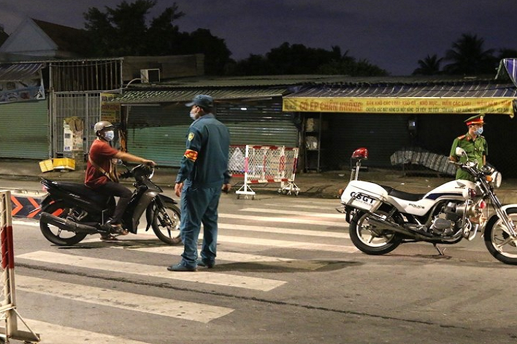 Lực lượng chức năng lập chốt kiểm soát lưu thông tại khu vực cầu Trường Đai giữa phường Thới An, quận 12 với phường 13, quận Gò Vấp. (Ảnh: Xuân Tình/TTXVN) 