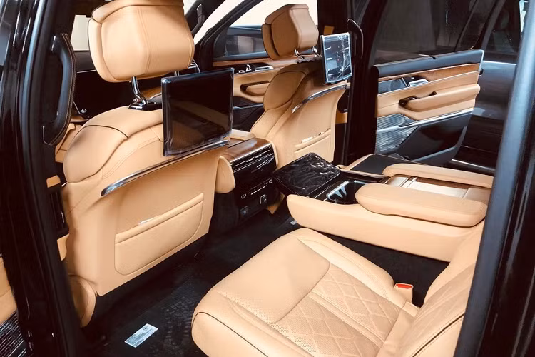 Mở cửa bước vào trong khoang lái, Jeep Grand Wagoneer 2022 có nội thất ấn tượng khi được trang bị mặt táp-lô hình đôi cánh, núm xoay chọn số bằng nhôm, vô lăng 2 chấu, ghế ngồi được bọc da Palermo khâu quả trám, ghế trước chỉnh điện 24 hướng với tính năng nhớ vị trí và mát-xa. Khác với xe Jeep Wagoneer 2022 khi 2 ghế thương gia nằm độc lập ở giữa là trang bị tùy chọn, người mua phải chi thêm tiền thì với khách chọn tậu xe Grand Wagoneer 2022 sẽ miễn phí.