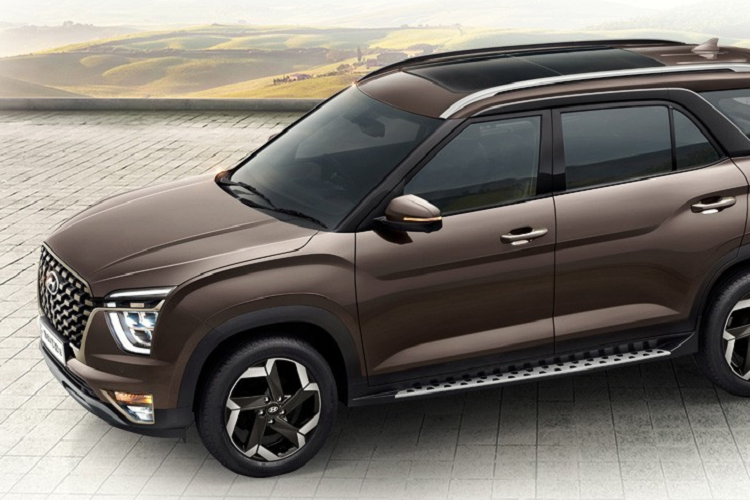 Không chỉ dài hơn, mẫu SUV Hyundai Alcazar giá rẻ này còn có một số điểm nhấn riêng trong thiết kế ngoại thất như lưới tản nhiệt, cản trước, kính cửa sổ thứ ba, nóc bằng phẳng hơn, bộ vành hợp kim 18 inch phối 2 màu thể thao, cửa cốp thẳng đứng hơn, cụm đèn hậu mới, cản sau tích hợp 2 ống xả giả và tấm ốp gầm giả.