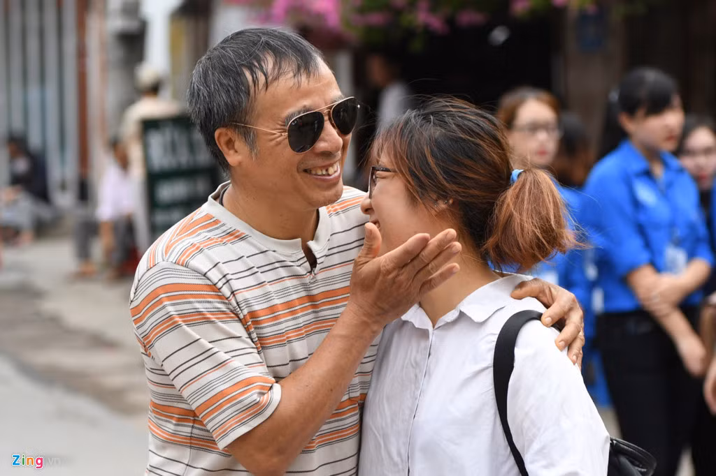 Tại điểm thi trường THPT Yên Hòa, quận Cầu Giấy, Hà Nội, ông Nguyễn Chí Tường (sống ở Lạc Long Quân) đưa con gái Nguyễn Minh Huyền đi thi từ sớm. Trước khi tạm biệt, ông âu yếm, chúc con làm tốt môn Ngữ văn. Nụ cười rạng rỡ của hai cha con khiến nhiều người cảm động. Ảnh: PV.