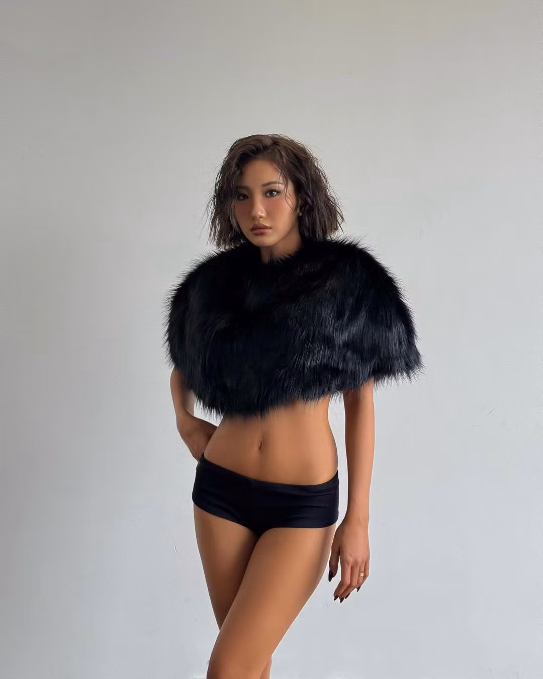 Từ ngày nhuộm da nâu, phong cách thời trang của Huyền 2k4 được nhiều người nhận xét có phấn táo bạo, phóng khoáng hơn trước. Trong loạt ảnh mới, cô nàng diện thiết kế áo choàng lông màu đen, kết hợp cùng chiếc quần siêu ngắn cùng màu đầy quyến rũ.