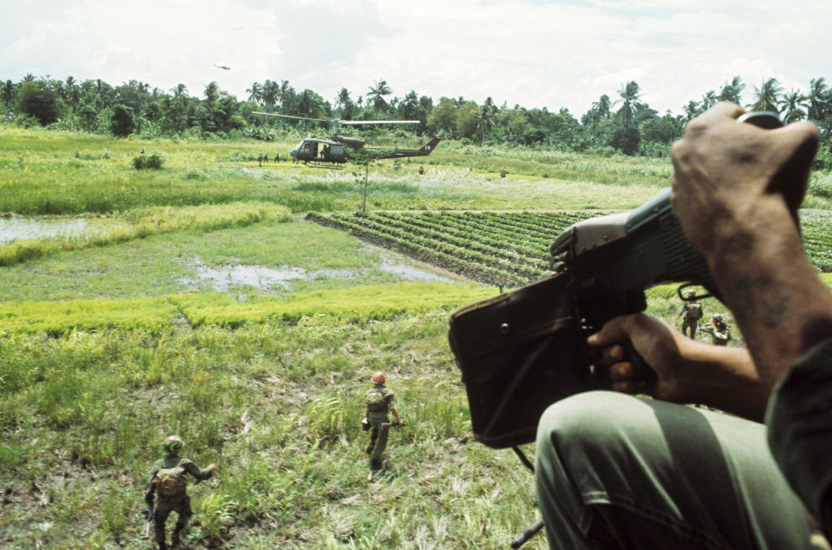 Các binh sĩ đổ bộ xuống cánh đồng từ máy bay trực thăng. Ảnh: Jean-Claude Sauer.
