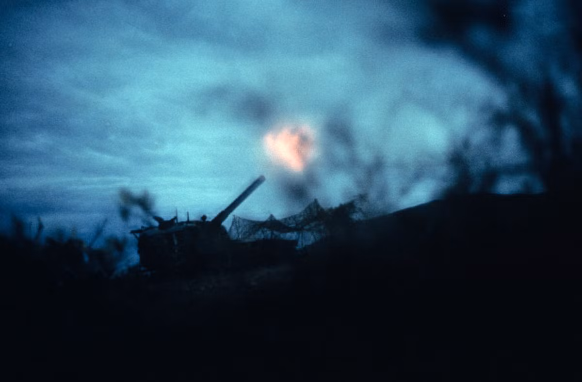 Một chiếc xe tăng Mỹ nhả đạn trong buổi hoàng hôn ảm đạm. Ảnh: Jean-Claude Sauer.