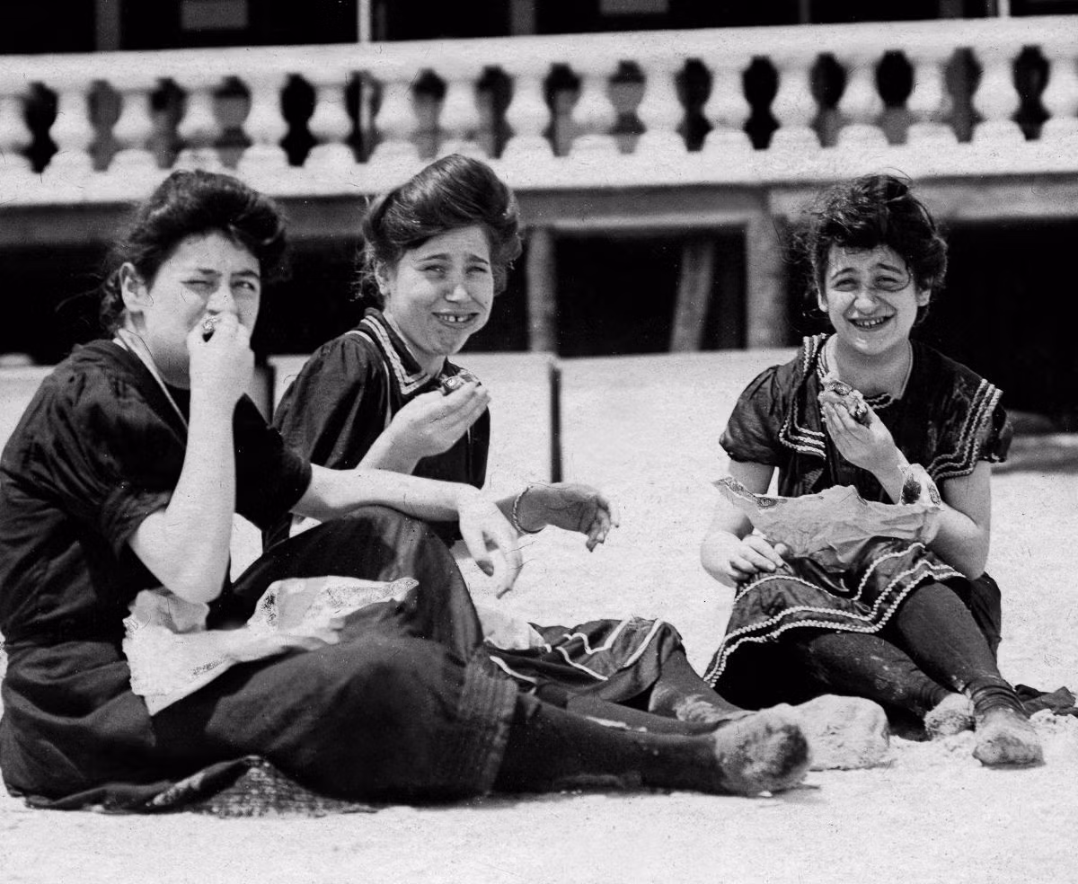 Những người phụ nữ thưởng thức đồ ăn nhẹ trên bãi tắm Coney, 1904. Ảnh: Getty.