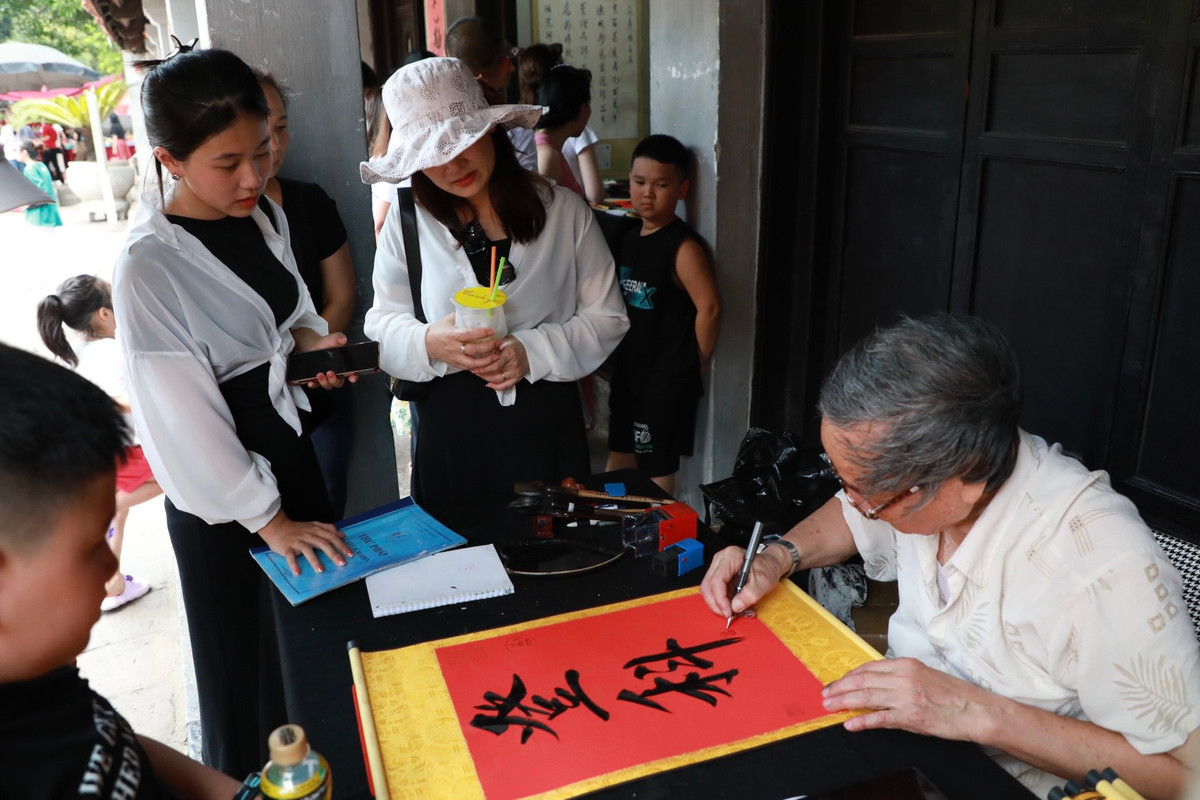 Sau khi lễ xong, nhiều thí sinh xin chữ thư pháp cầu mong may mắn đỗ đạt.