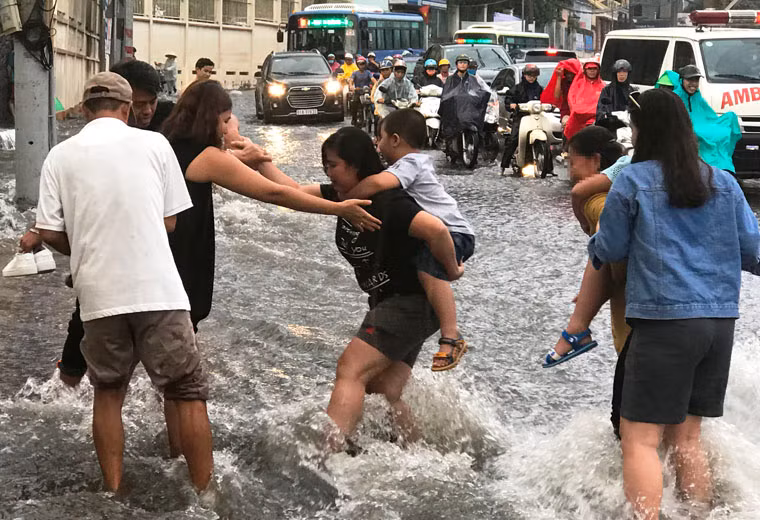 Nhiều đứa trẻ la khóc do hoảng sợ vì chứng kiến cảnh tượng nước mưa cuồn cuộn trên đường.
