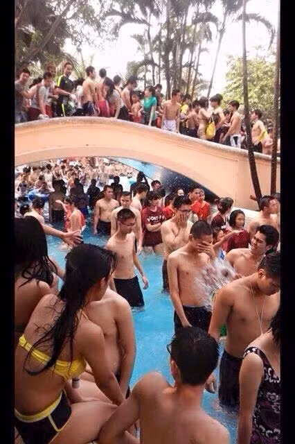 Hình ảnh dòng sông lười chật cứng, người người chen chúc nhau đi lại ở cây cầu phía trên. Có thể thấy trong bức ảnh này, rất nhiều người không mặc đồ bơi theo đúng quy định của công viên. Do phòng gửi đồ quá tải nên nhiều người mặc luôn cả áo phông, đồ thường ngày để xuống bơi lội.