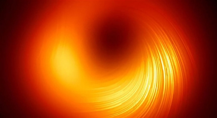 Hố đen siêu nặng ở trung tâm của thiên hà M87 lần đầu tiên được ghi lại và có thể được quan sát qua ánh sáng phân cực. Những đường xoắn cho thấy từ trường gần rìa hố đen.