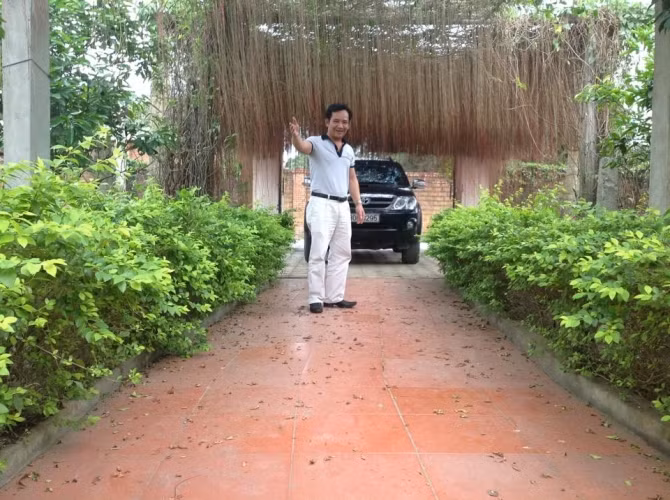 Lối vào khu nhà mướt mắt với những hàng cây, giàn dây leo xanh tươi mơn mởn.