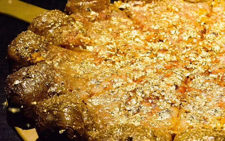 Chiếc bánh pizza dát vàng mang tên Pizza Royale 007 được bán đấu giá trên trang mua sắm trực tuyến và đạt kỉ lục 4.200 USD. (Ảnh: KT)