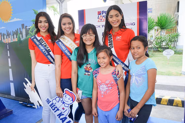 Lệ Hằng cùng đại diện Belize, Kosovo tham gia một số trò chơi, phát quà cho khách hàng khi đến trạm xăng.