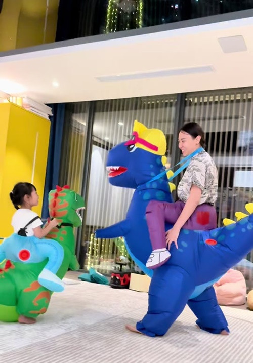 Đàm Thu Trang - Cường Đô la cùng các con mặc trang phục mô hình khủng long chơi đùa tại nhà. Ảnh: TikTok Đàm Thu Trang.