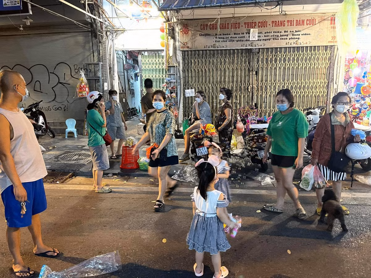 Mặc dù có chốt chặn nhưng có rất nhiều phụ huynh vượt rào cùng con em mình để vào phố Hàng Mã.