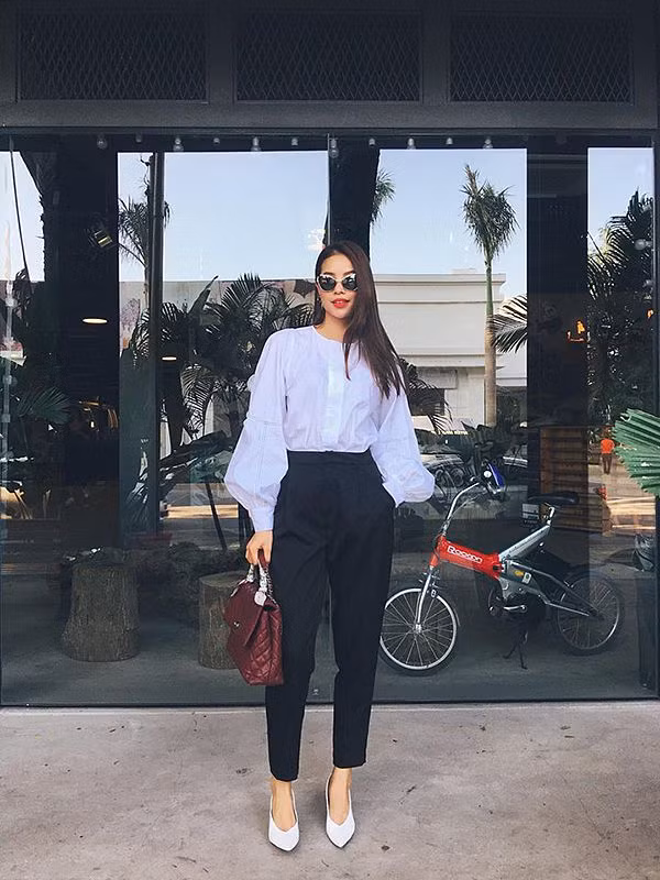 Phạm Hương lại chọn sơ mi tay phồng để kết hợp cùng quần âu ống côn màu sắc tương phản nhằm giúp mình thể hiện vẻ đẹp hiện đại và thanh lịch. Người đẹp cũng không quên hoàn thiện set đồ bằng mẫu túi Chanel tông màu đỏ đậm sang trọng.