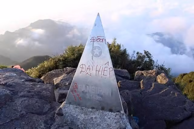 Trước đây, khi chưa xây dựng đường cáp treo đưa du khách lên đỉnh núi, cột mốc Fansipan cũng từng là nạn nhân bị vẽ bậy "không thương tiếc". Ảnh: Hà Nguyễn.