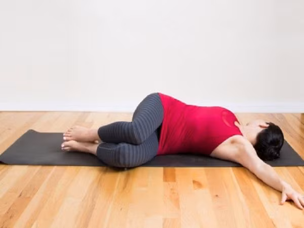 Với bài tập này, bạn hãy nằm duỗi thẳng dưới sàn nhà, hai tay dang sang ngang, hít sâu, đá chân sang bên phải. Thở ra, trả người về tư thế ban đầu. Sau đó lặp lại hít sâu, đá chân sang bên trái. Ảnh: thoaihoacotsong.