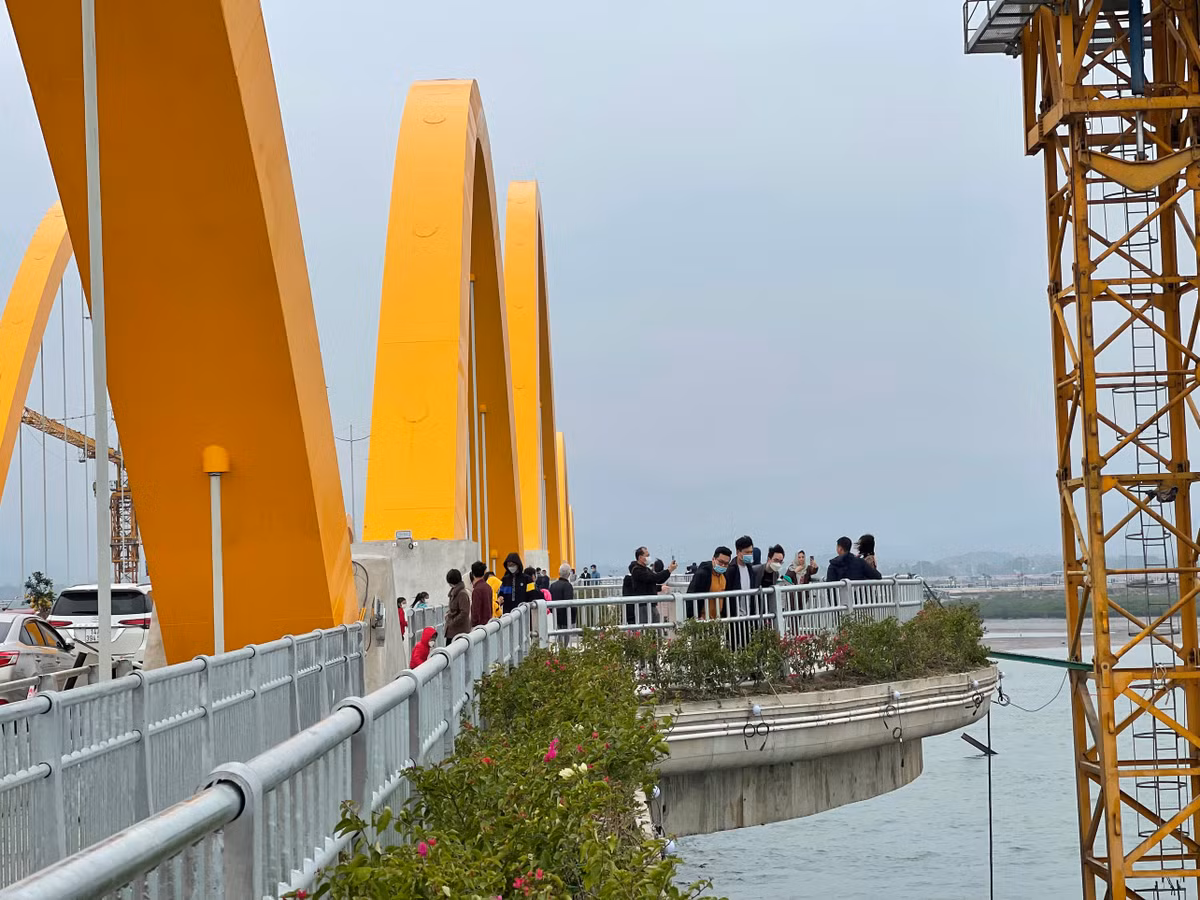 Người dân đỗ xe dọc cây cầu để tranh thủ chụp bức ảnh “check in” đầu năm mới tại cầu Tình Yêu.