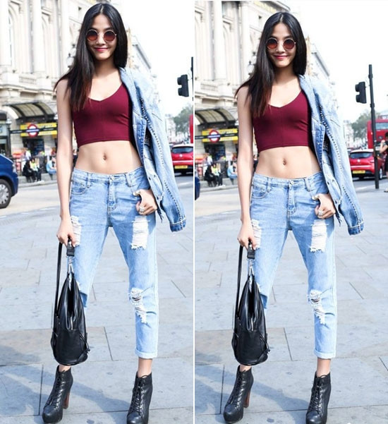Hoàng Thùy khoe khéo vòng eo con kiến và đôi chân dài miên man với set đồ quần jean và áo hai dây croptop màu đỏ đô. Ảnh: voh.