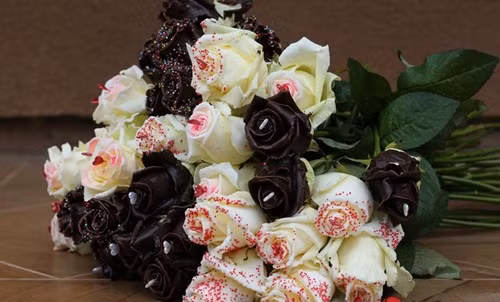 Ở Việt Nam, hoa hồng nhập ngoại phủ socola giá nửa triệu đồng/cành cũng là một trong những món quà xa xỉ được nhiều đại gia chịu chi mua tặng bạn gái trong dịp này. Ảnh: Zing.