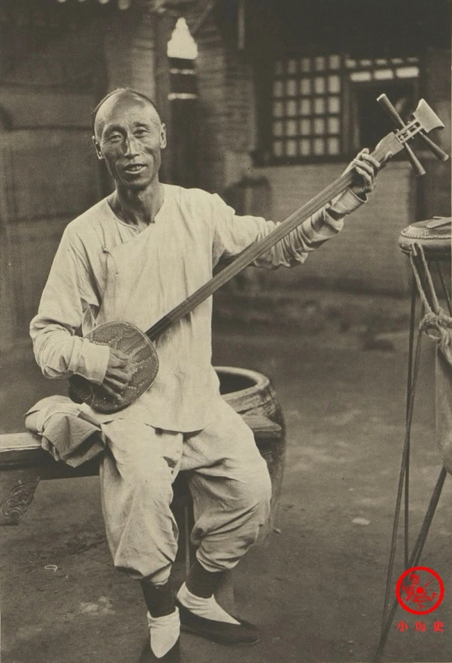 Một người đàn ông chơi tam huyền cầm (tức đàn ba dây).