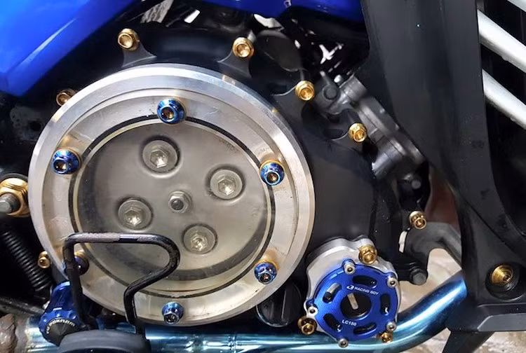 Tuy nhiên ở phía bên bưởng côn, chủ xe đã nâng cấp lên bưởng trong suốt, nhìn thấy hoạt động của bộ côn ở bên trong. Nằm ngay dưới là bộ nắp nhớt nhôm CNC của Racing Boy.