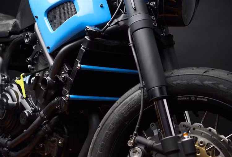 David muốn tạo ra một chiếc xe đơn giản nhưng cá tính và không ảnh hưởng tới hiệu năng. Chính vì vậy toàn bộ "dàn chân" trước của xe đã được anh thay thế hoàn toàn với cặp phuộc USD cùng hệ thống phanh từ Yamaha R6, kết hợp với niềng căm Borrani kèm lốp Pirelli Anakee 3.