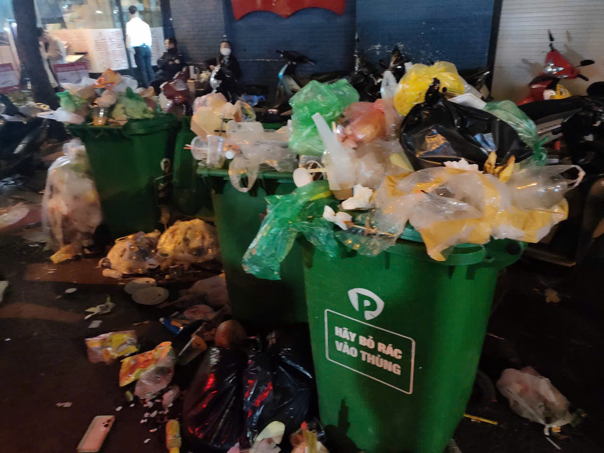 Những thùng rác quá tải, rác tràn ra ngoài, tràn ra cả đường.