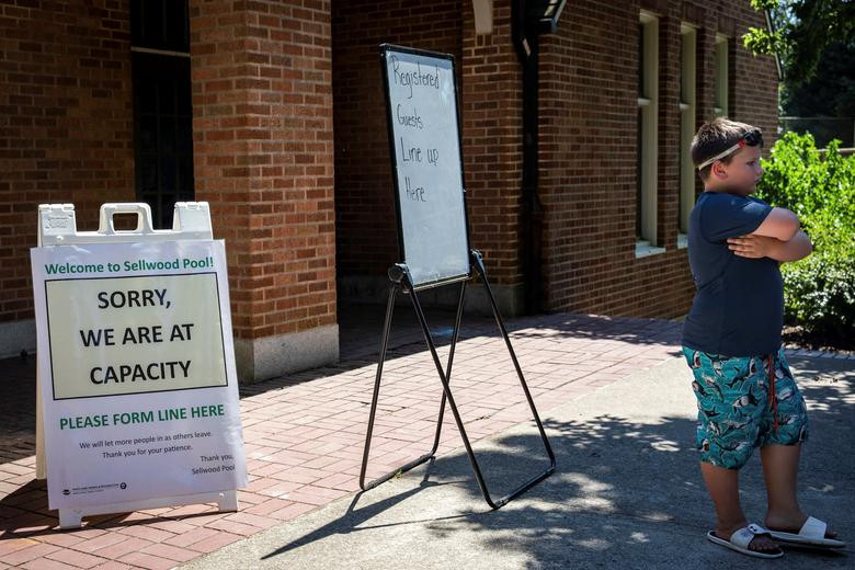 Nhiều người phải xếp hàng chờ đến lượt vào bể bơi công cộng tắm mát ở Portland do bể bơi quá tải.