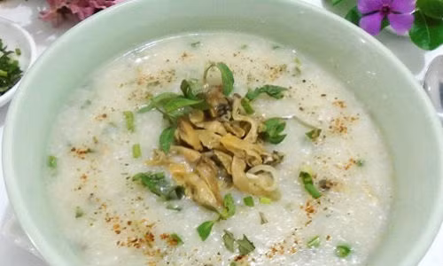 Thịt trai thái miếng nhỏ, xào với hành khô cho săn lại. Khi cháo nhừ, múc ra tô, rắc trai xào cùng hành, răm, quẩy và hat tiêu lên trên. Ảnh: 8monngonmoingay.
