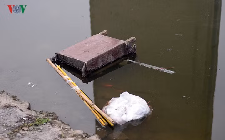 Tại hồ Tây, ban thờ cùng nilon rác thải theo cá xuống nước.