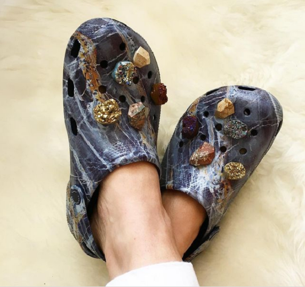 Đôi crocs này là tác phẩm của nhà thiết kế người Anh Christopher Kane. Nó được xem là đôi "dép của người giàu" vì phủ toàn đá quý.