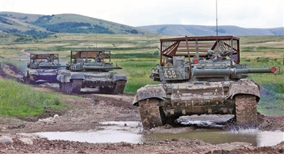 Mới đây, bức ảnh về cuộc tập trận của một đơn vị xe tăng, thuộc Lực lượng Phòng vệ bờ biển thuộc Hạm đội Biển Đen của Nga, đã gây chú ý khi tháp pháo của những chiếc xe tăng chiến đấu chủ lực T-72B3, đều được bọc bằng kết cấu khung thép lồng khổng lồ, thoạt nhìn thì có vẻ như được đội “mũ sắt”.