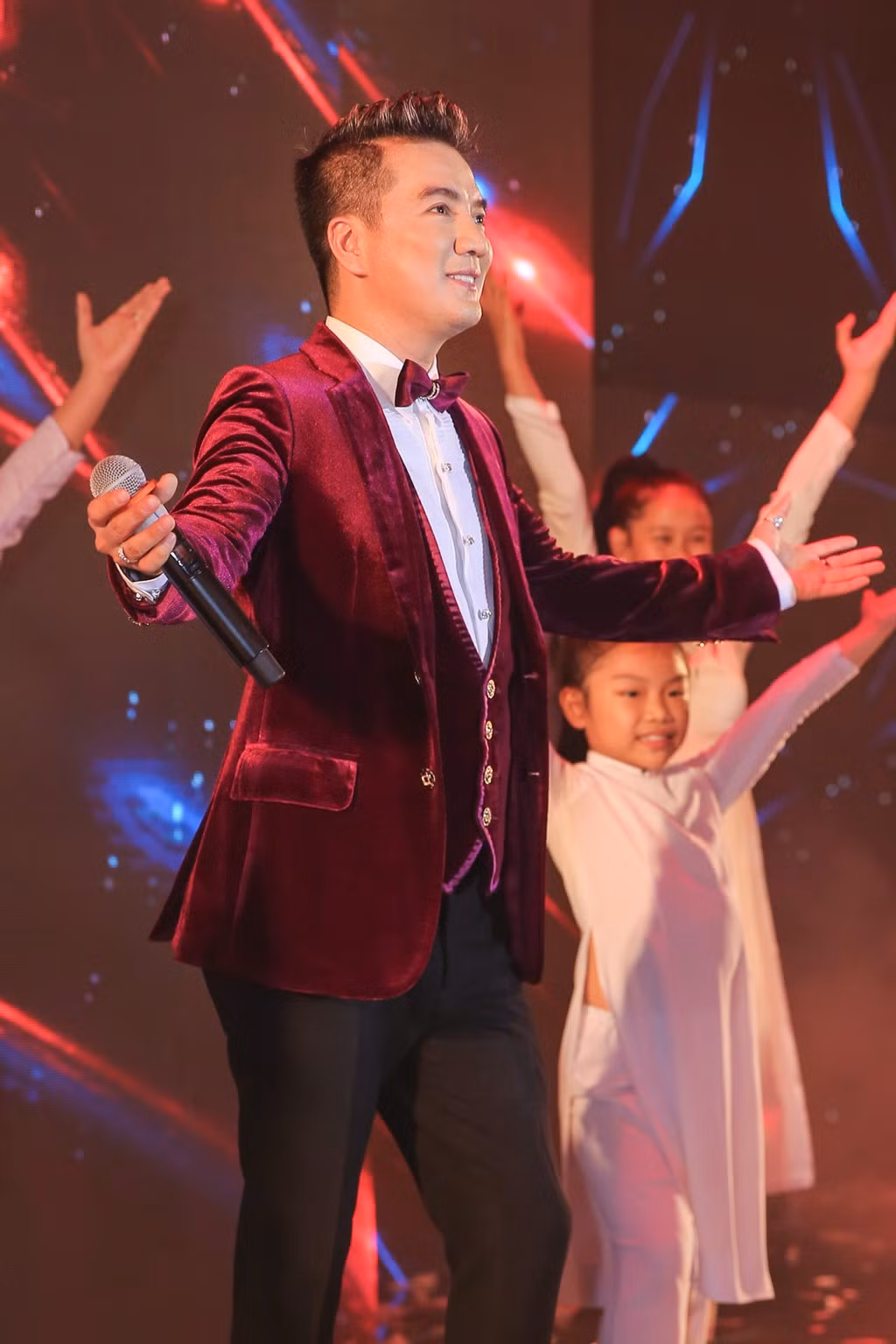 Không chỉ là khách mời dự tiệc, Đàm Vĩnh Hưng còn trình diễn một số ca khúc sở trường chúc mừng đôi "tân lang, tân nương". Giọng ca Bình minh sẽ mang em đi diện áo vest nhung màu rượu chát sành điệu.