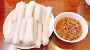 Với cái tên thú vị, bánh gật gù khiến bạn tò mò và không thể cưỡng lại khi thử món này. Bánh có màu trắng tinh, mềm mịn và có độ dai nhẹ. Khi ăn, bánh được chấm cùng với nước mỡ gà, tạo nên sự béo ngậy nhưng vẫn giữ được hương vị thanh nhẹ. Ảnh Vinpearl