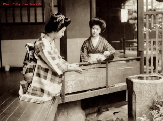 Hai người phụ nữ Nhật Bản mặc kimono, búi tóc cao cùng lối trang điểm truyền thống xuất hiện bên phía ngoài nhà. Ảnh QQ.