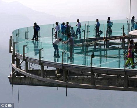 Một du khách sợ hãi khi đi trên nền kính trong suốt… (Nguồn Daily Mail)