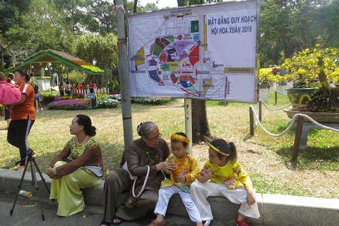 Trẻ em vui vẻ được gia đình cho mặc áo đẹp đi chơi tết