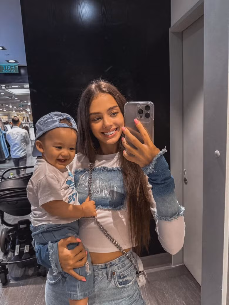 Dianka Zakhidova diện 1 combo thoải mái chuẩn đồ ở nhà là áo croptop và quần đùi, đứng trước gương và tạo dáng, chụp ảnh.