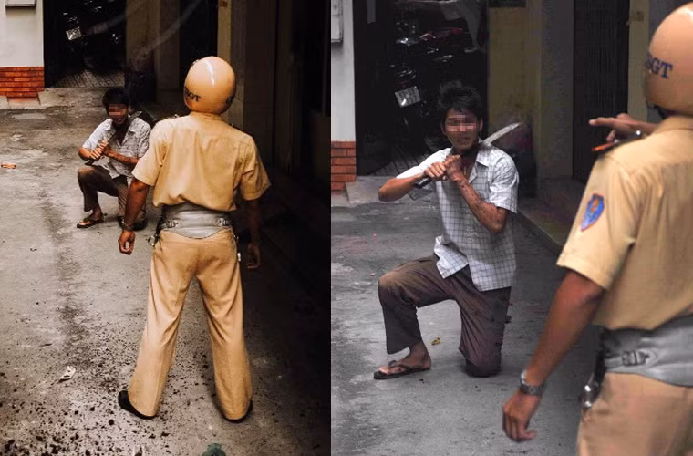 Quyết không cho tội phạm tẩu thoát và dù đối tượng liên tục dí dao đe dọa, anh Thanh vẫn cương quyết bắt cho bằng được tên cướp. Chạy đến cuối hẻm là đường cùng, tên cướp quỳ xuống đất, dọa cắt cổ tự tử nếu CSGT xông vào. (Ảnh Dave MacMillan)