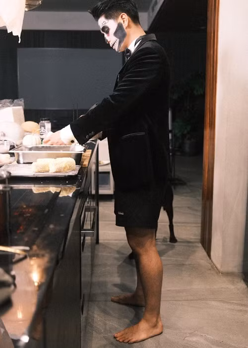 Ảnh hậu trường nấu ăn của Huy Trần đầy hài hước bởi anh mặc vest cùng quần ngắn. Ảnh: FB Huy Trần.