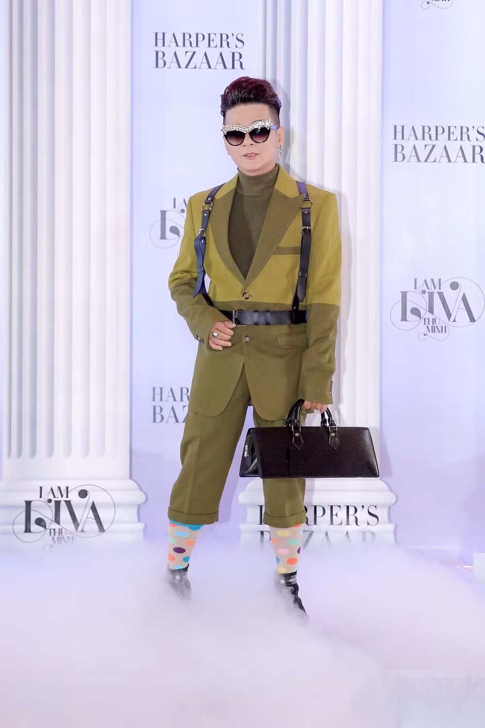 Vũ Hà nổi bật trong bộ cánh mang màu xanh quân đội bắt mắt. Anh tếu táo khi kết hợp cùng tất chấm bi sặc sỡ và kính mắt kiểu cách, hiện đại.